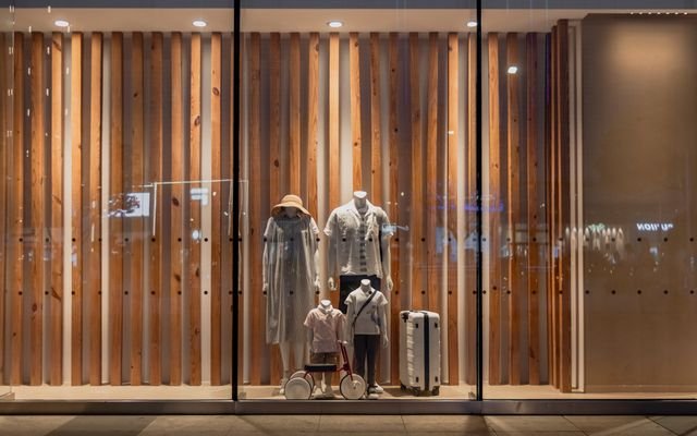 Elegant storefront display with mannequins in fashionable attire, seen in Wuhan, China.