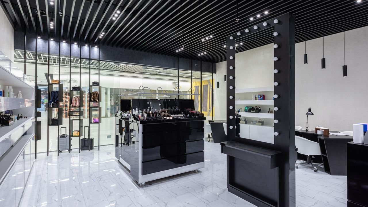 Highly stylized contemporary makeup store with elegant furnishings and lighting.