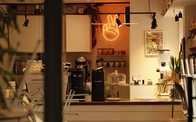 Warm ambiance in a modern café with stylish neon peace sign lighting.