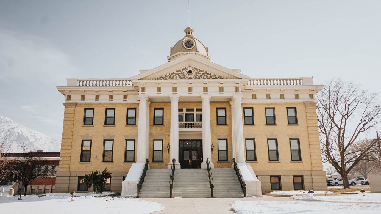 A prominent historic building in Brigham City, Utah, covered in snow during winter.