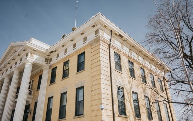 Low angle view of the historic Box Elder County Courthouse with columns and blue sky, Brigham City, Utah.