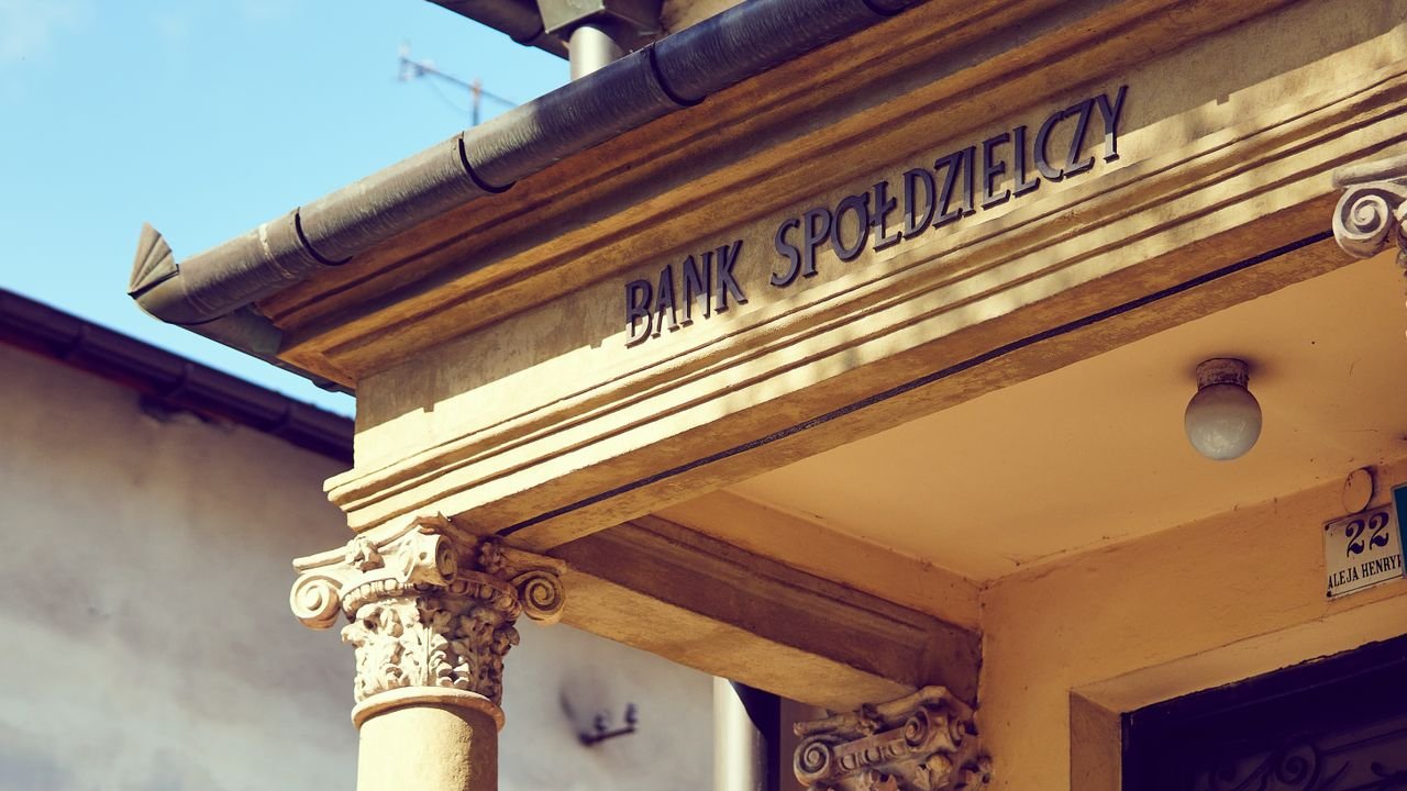 Detailed view of a historic Polish bank facade with classic architectural columns.