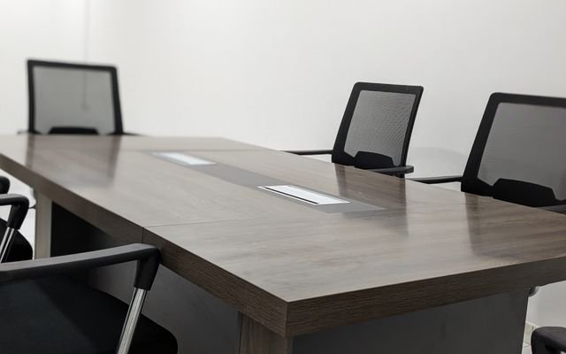 Sleek and empty conference room with modern furniture and minimalist design.