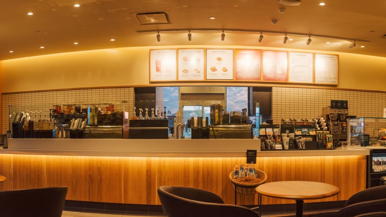 Spacious coffee shop interior with illuminated counter, perfect for a cozy gathering.