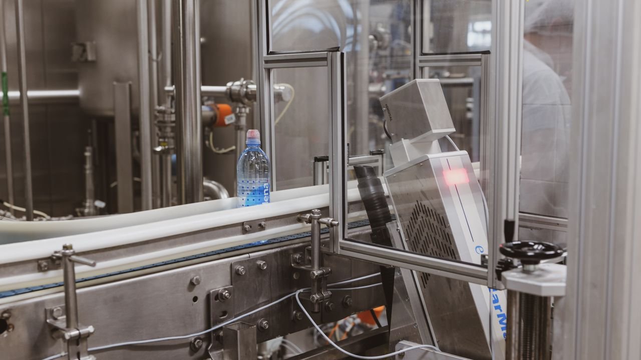 Close-up of a plastic bottle in a modern factory bottling production line.