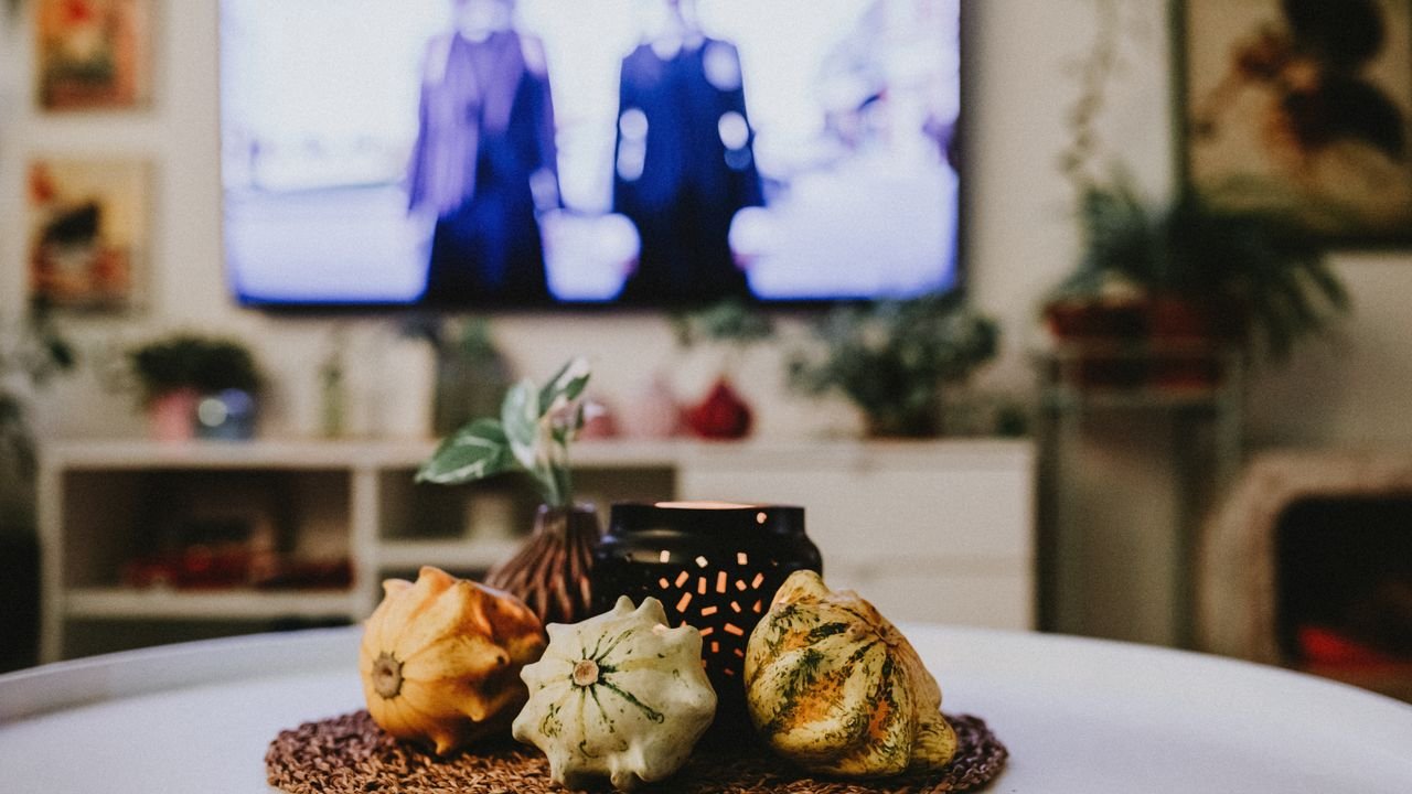 Warm and inviting indoor scene featuring decorative gourds and ambient lighting on a table.