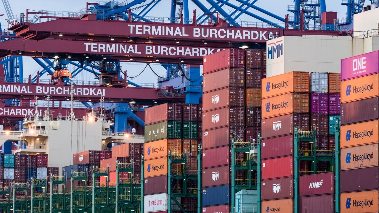 View of shipping containers and cranes at Hamburg's Burchardkai terminal.