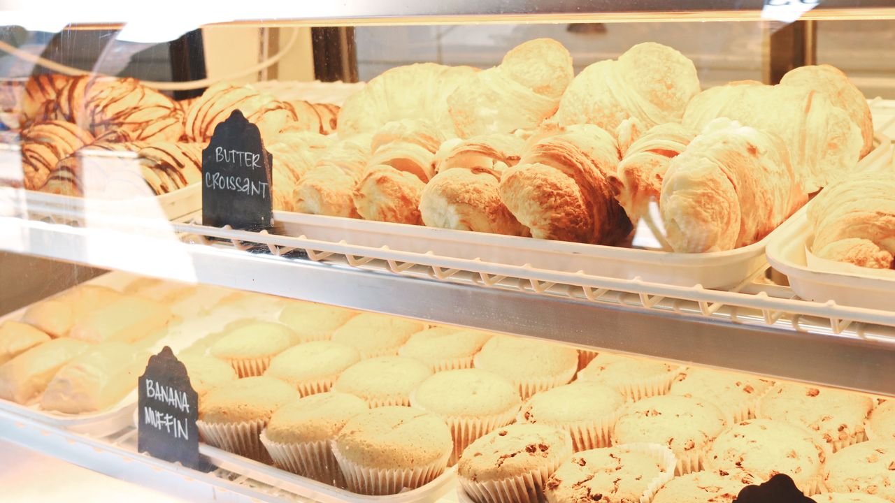 A tempting display of croissants and muffins fresh from the bakery, ready to enjoy.