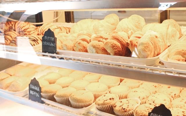 A tempting display of croissants and muffins fresh from the bakery, ready to enjoy.