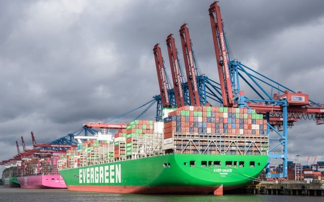 Large cargo ships docked at Terminal Burchardkai in Hamburg harbor, Germany.
