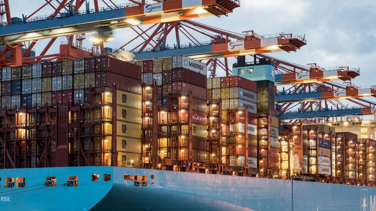 A vibrant cargo ship loaded with containers at Hamburg harbor, showcasing maritime industry.