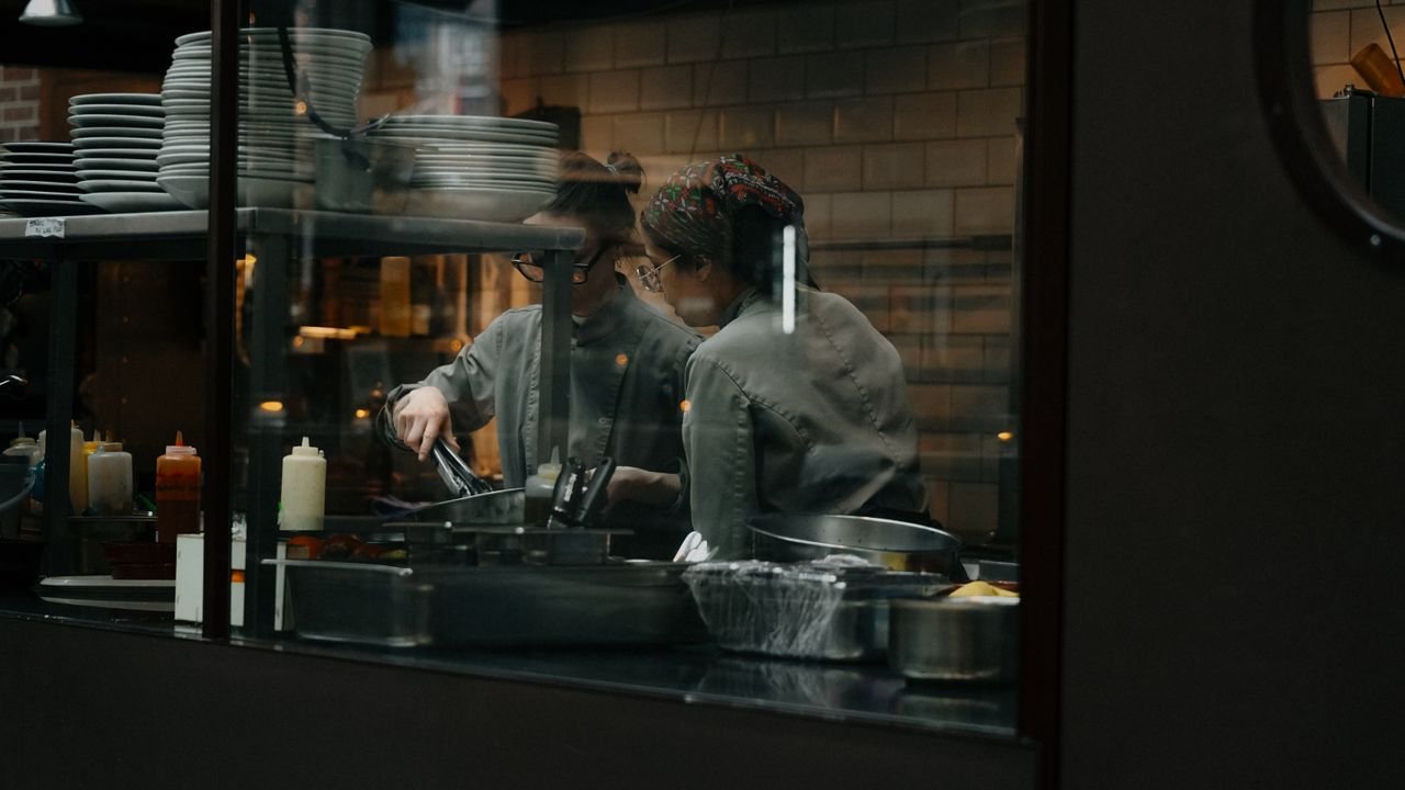 Candid shot of chefs cooking in a restaurant kitchen in Amsterdam.