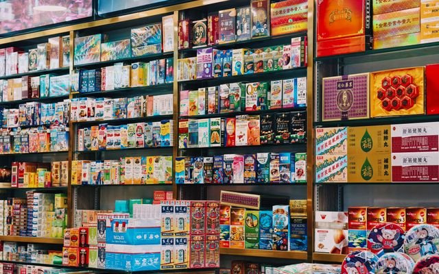 Bright and colorful display of various Asian products on supermarket shelves.