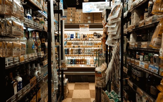 Explore a bustling Tokyo convenience store aisle packed with diverse products and merchandise.