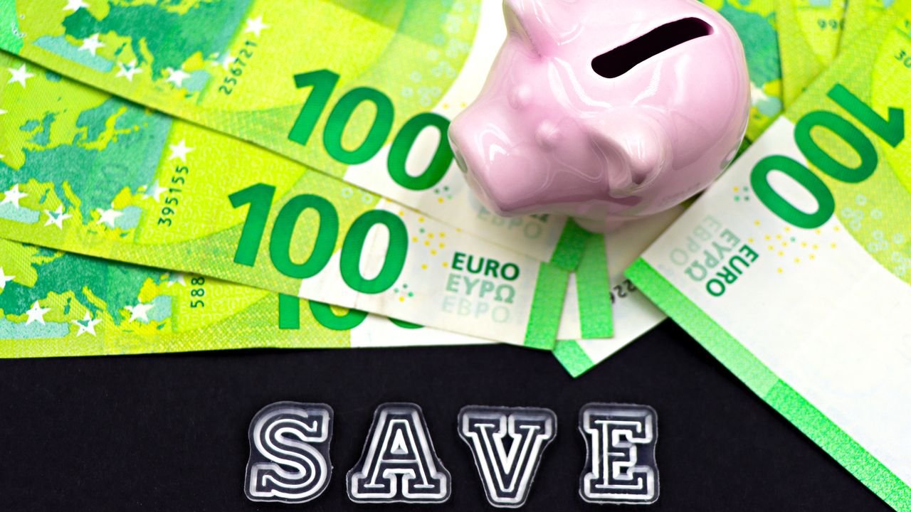 A piggy bank on euro bills with 'save' text highlights money saving concepts.