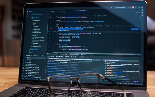 Laptop screen showing debugging software with code, perfect for tech and software development themes.