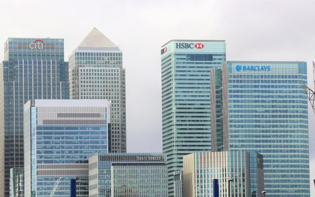 Modern skyline of Canary Wharf featuring iconic bank skyscrapers like HSBC and Barclays.