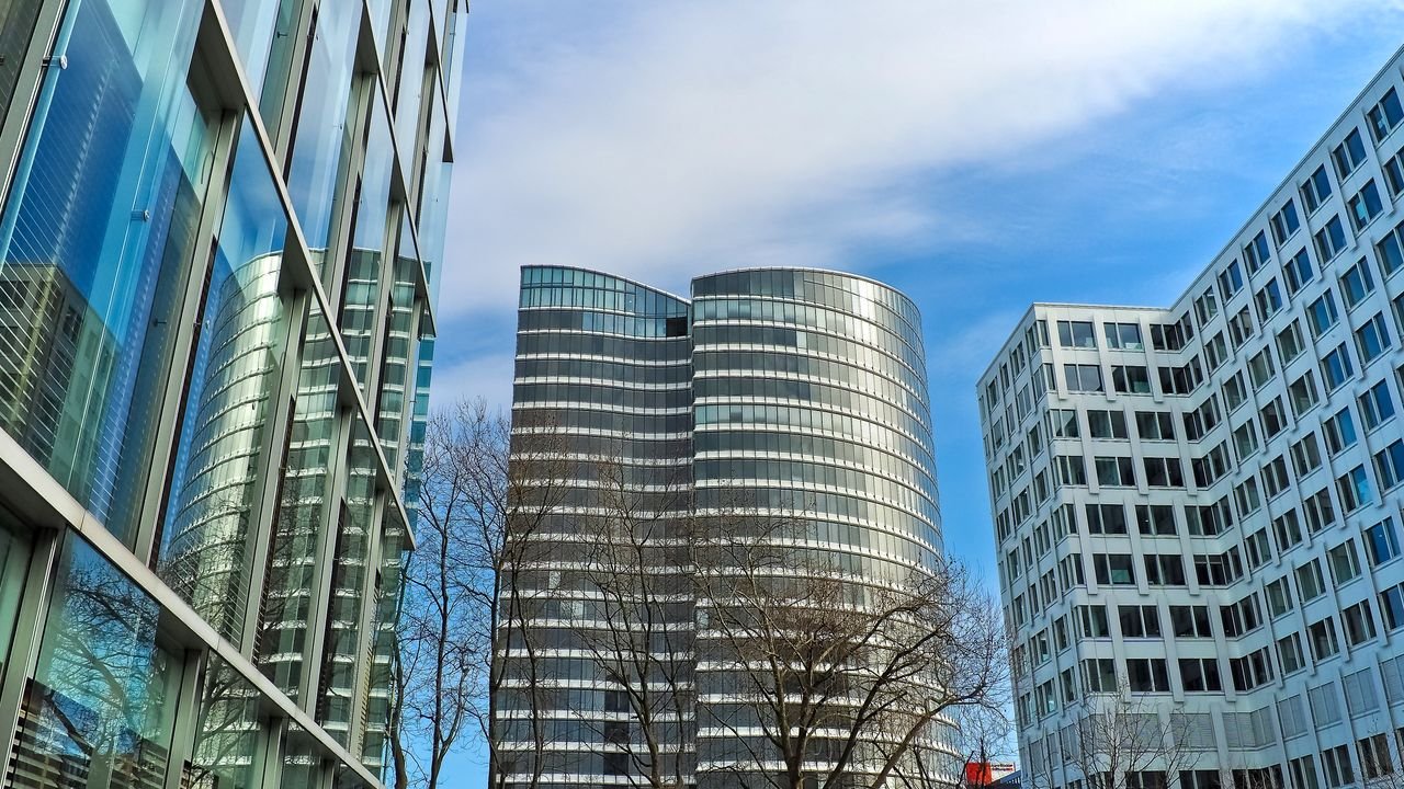 A striking view of modern skyscrapers against a clear blue sky, showcasing contemporary architectural design.