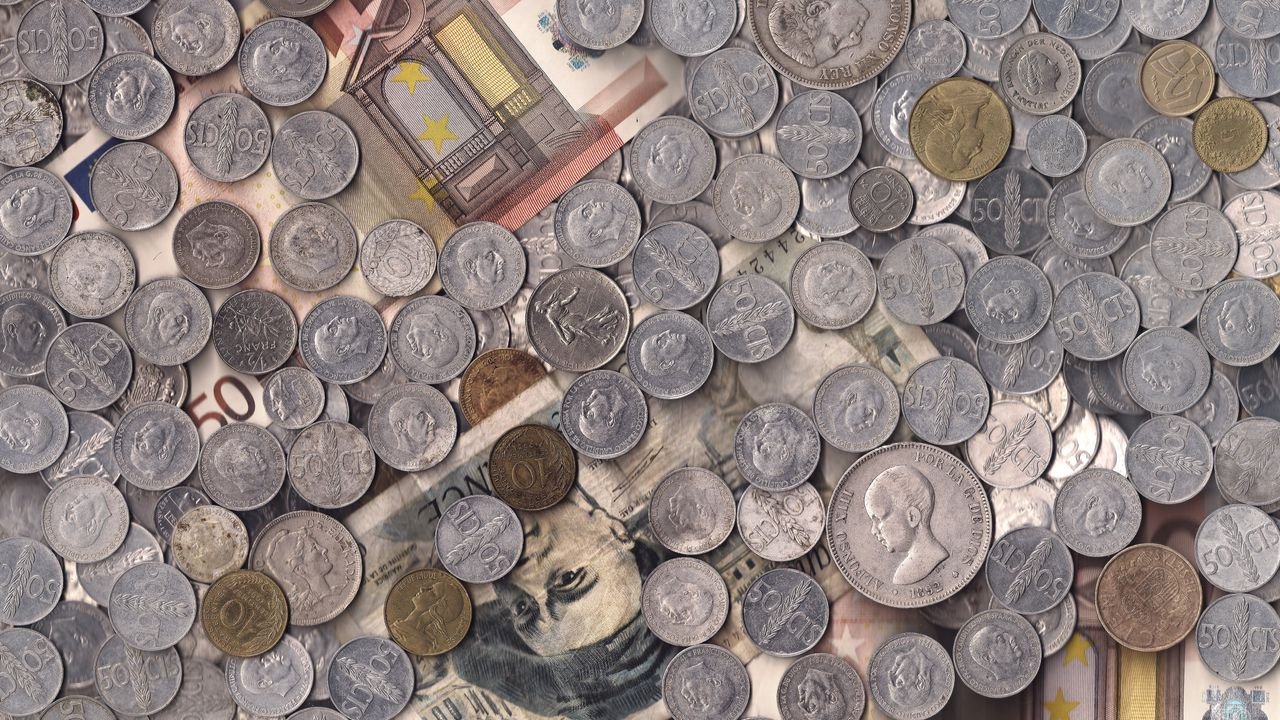 A collection of various European currency coins and notes in a scattered arrangement.