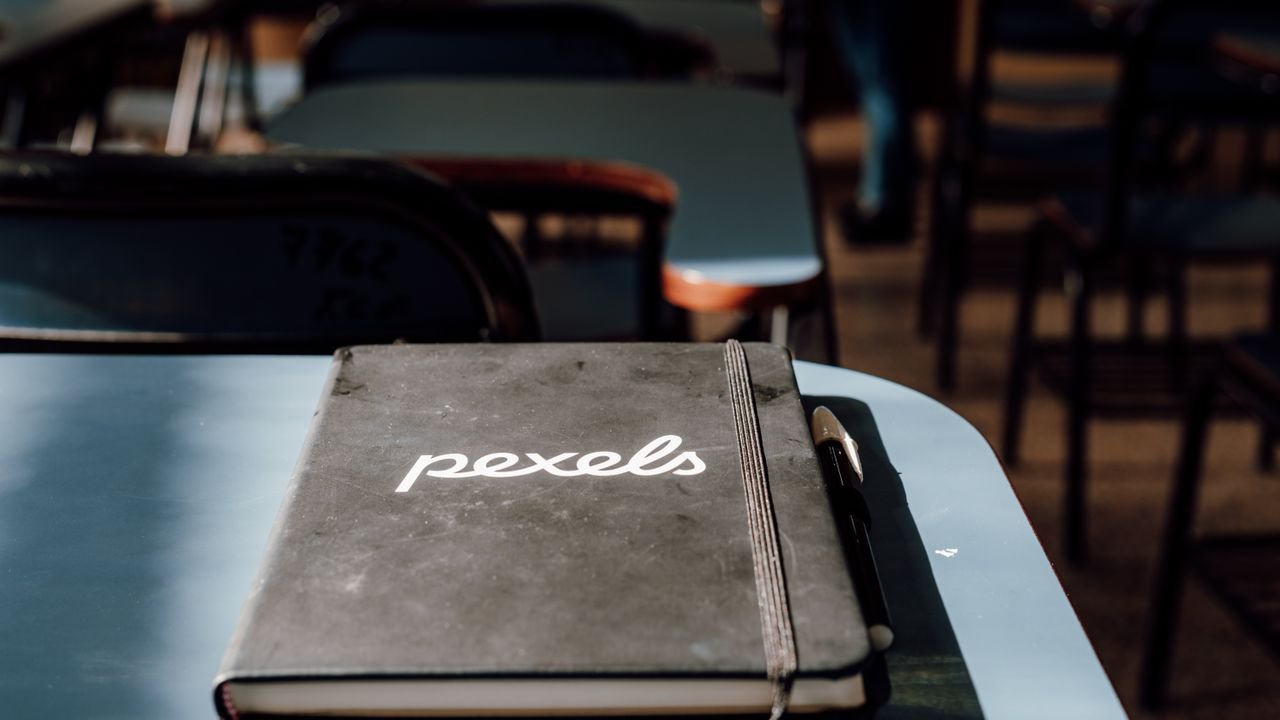A close-up of a notebook and pen in a classroom setting in Buenos Aires, Argentina.