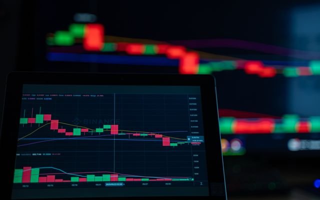 A close-up view of cryptocurrency trading charts showing a bearish trend in a digital market on a computer screen.