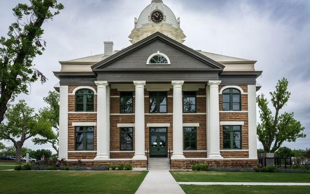 Classic architectural design of Mason County Courthouse, Texas amid lush greenery.