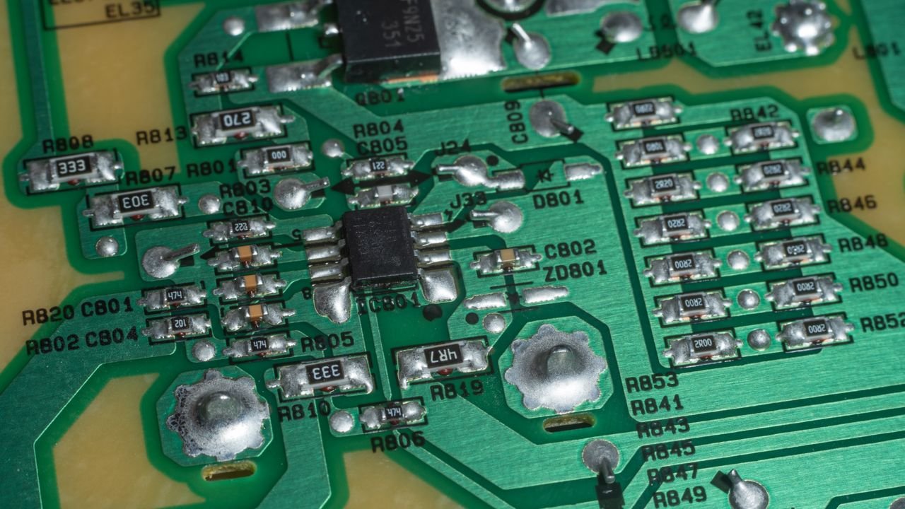 Detailed view of electronic circuit board components and soldered connections.
