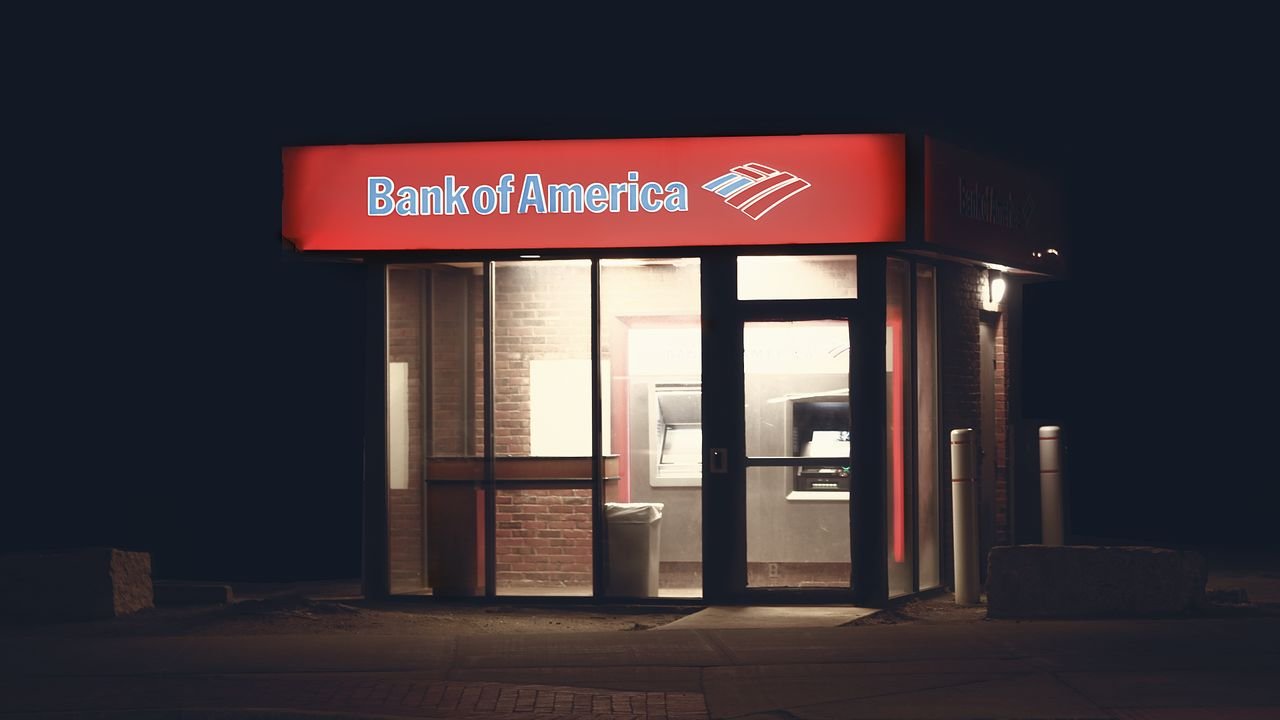 Illuminated Bank of America ATM structure against a dark nighttime backdrop in Boston.