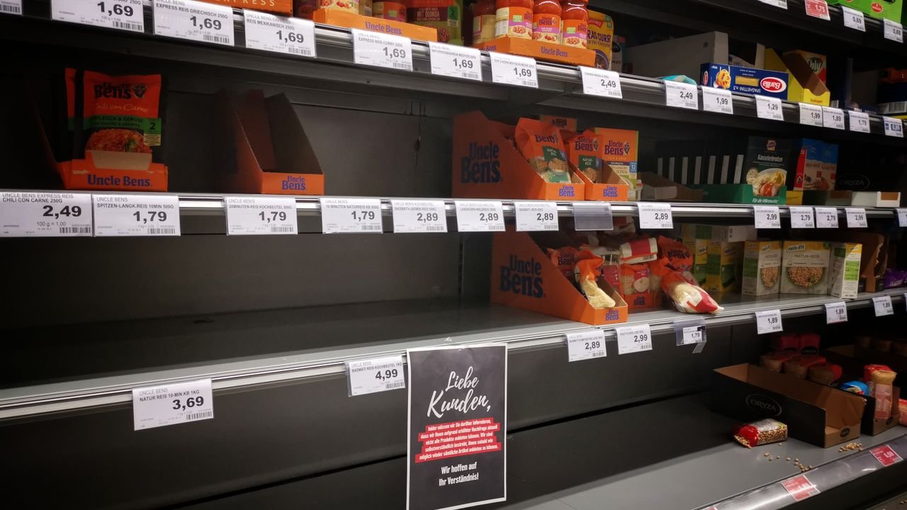 Half empty shelves with assorted products in jars and containers in supermarket during quarantine