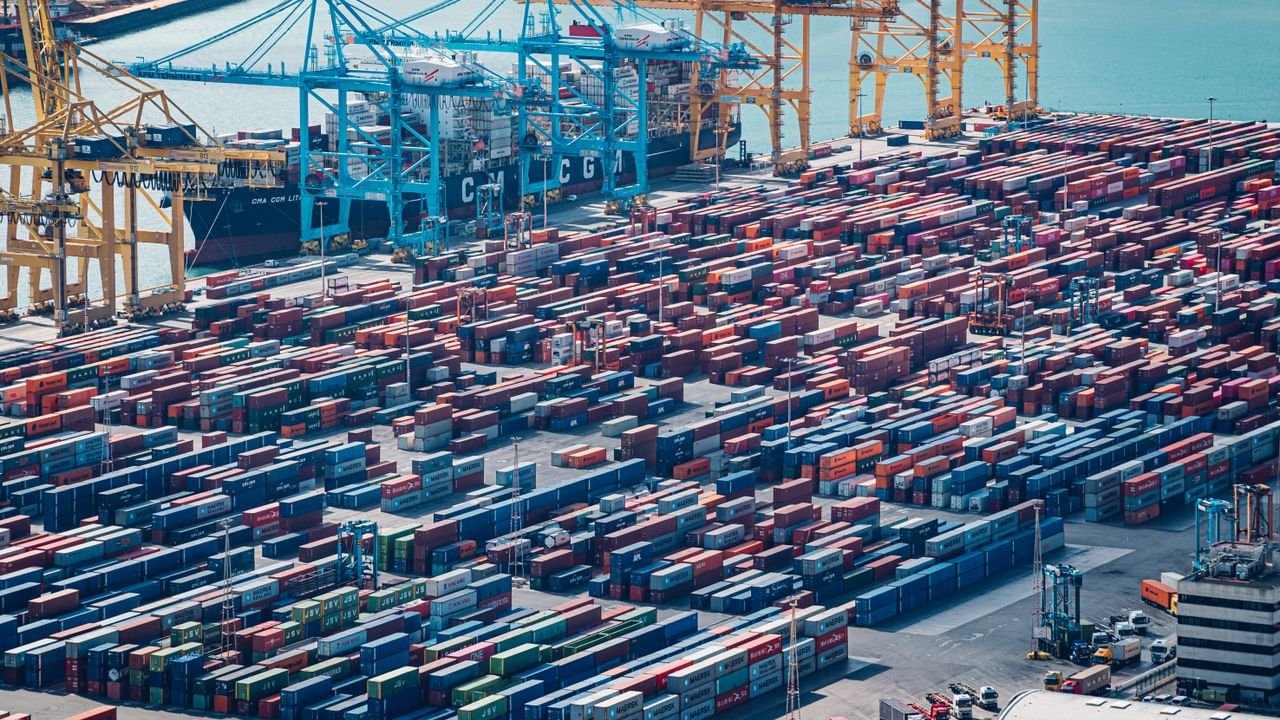 A drone shot of shipping containers at Barcelona Port, Spain, showcasing busy maritime activity.