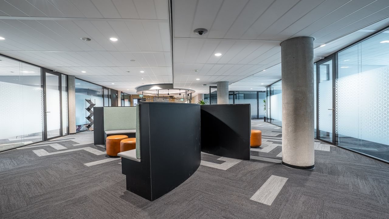 Spacious modern office interior featuring contemporary furniture and open workspace.