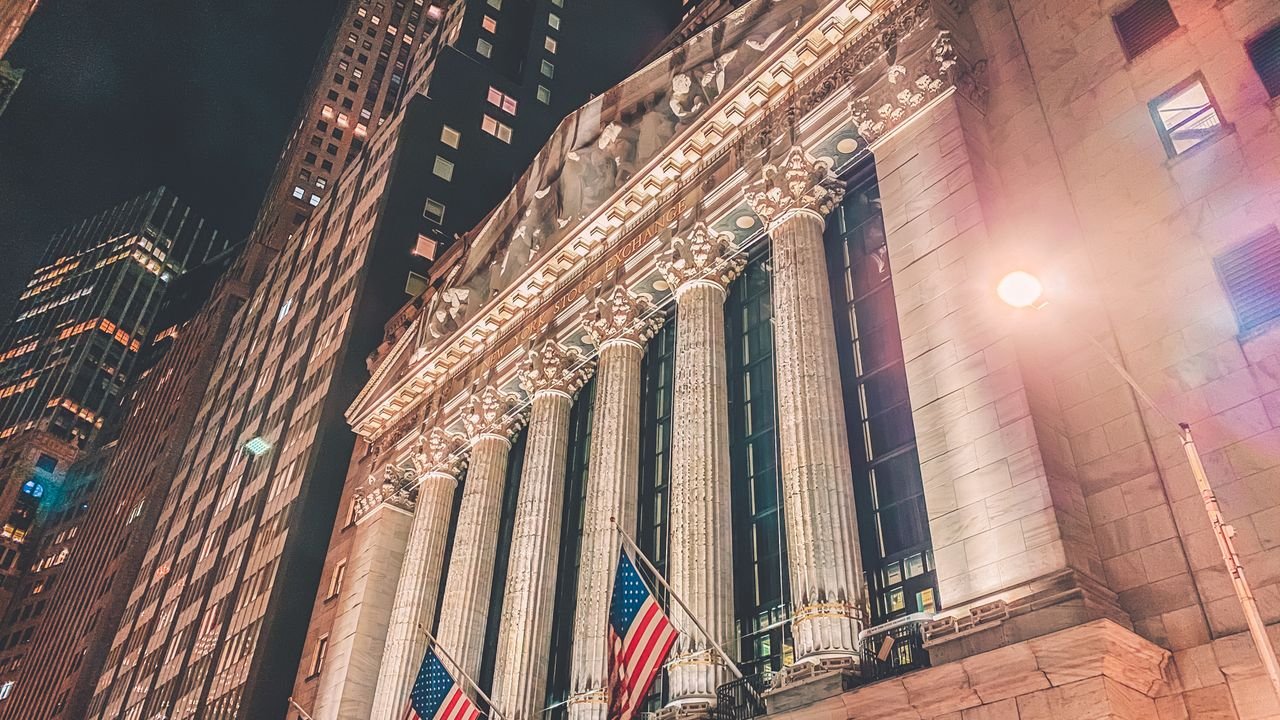 A striking night view of the New York Stock Exchange's illuminated facade in Manhattan.