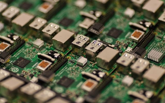 Detailed shot of a Raspberry Pi circuit board showcasing its components, USB ports, and microchips.