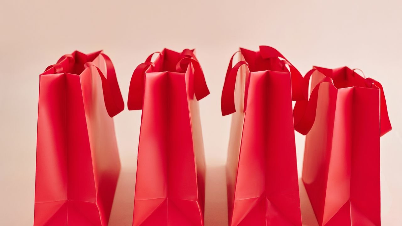 A row of vibrant red shopping bags for retail or gift concepts.