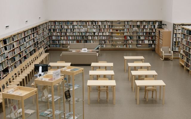 A serene library with bookshelves and wooden furniture, ideal for reading and study.
