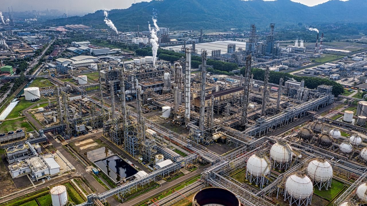 Aerial view of a large industrial oil refinery in Banten, Indonesia with storage tanks and pipelines.