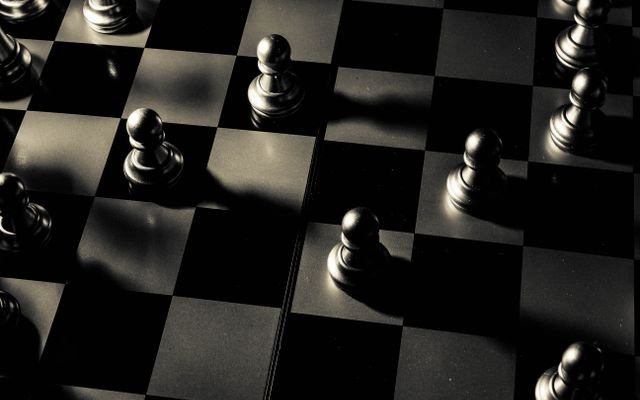 Elegant chessboard with pawns strategically placed, creating a dramatic scene.