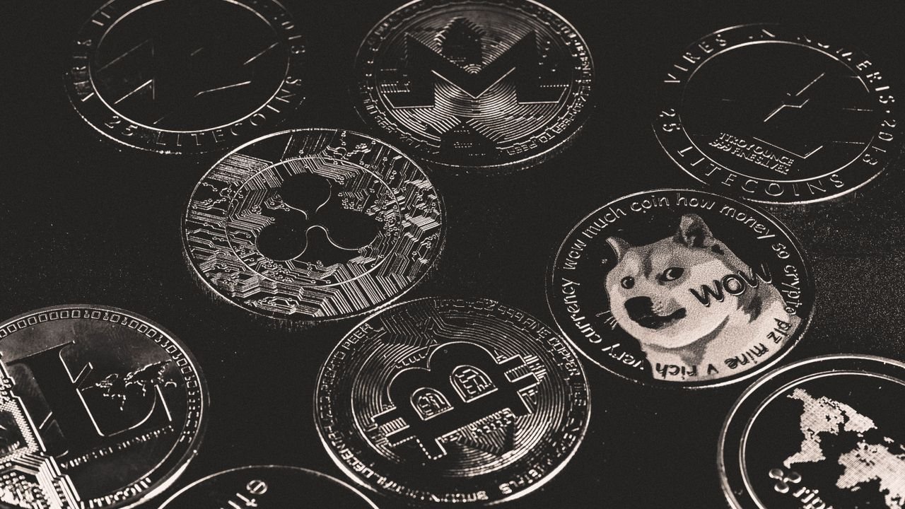 A collection of various cryptocurrency coins including Bitcoin, Ethereum, and Dogecoin.