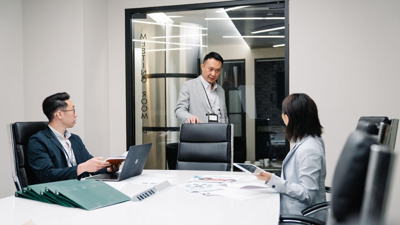 Business professionals in a meeting room engaged in teamwork and strategic planning.