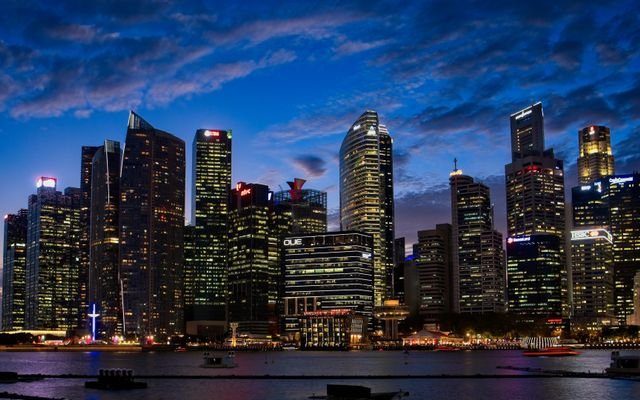Spectacular view of Singapore's skyline with illuminated skyscrapers against a twilight sky.