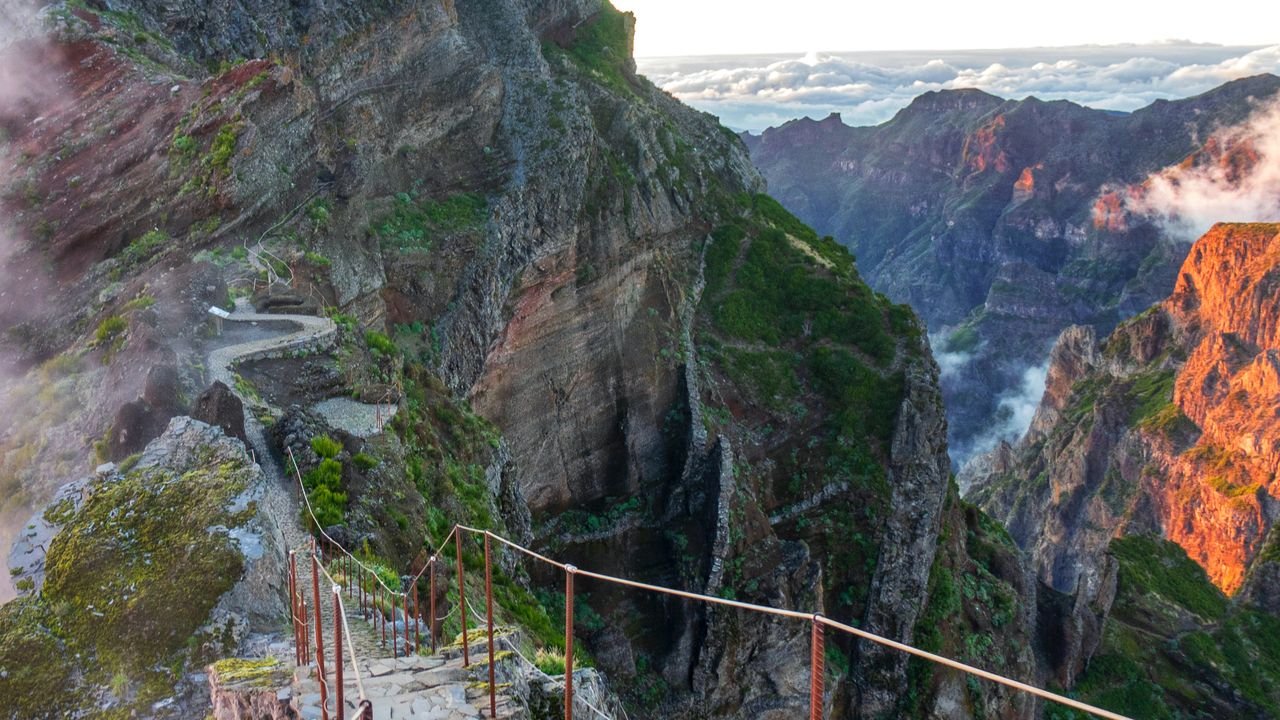 Experience stunning mountain views and scenic trails in Madeira, Portugal during sunrise.